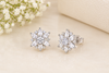 Floral Diamond Stud Earrings on Cream Surface